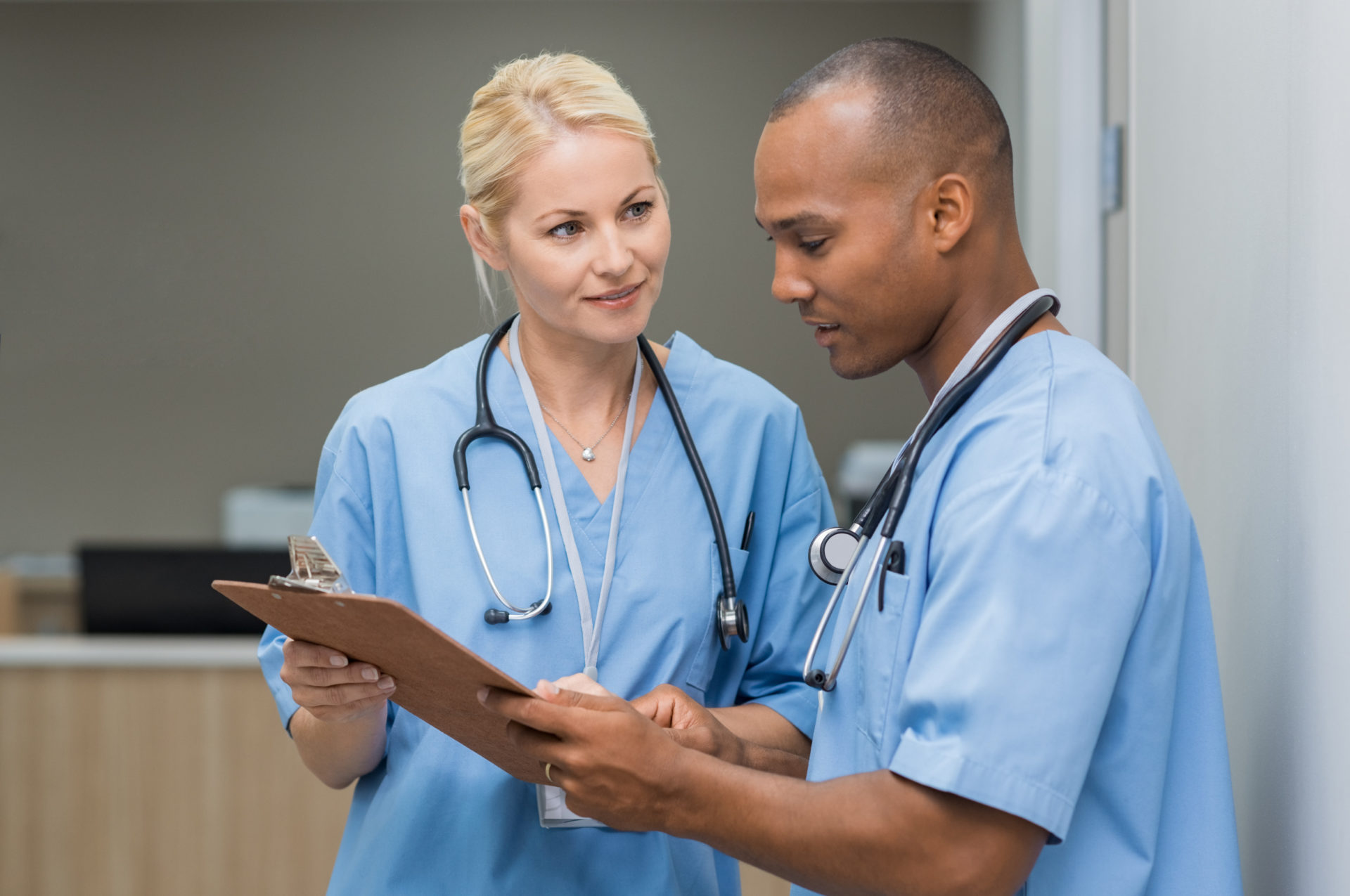 male and female nurses reading a document at the hospital