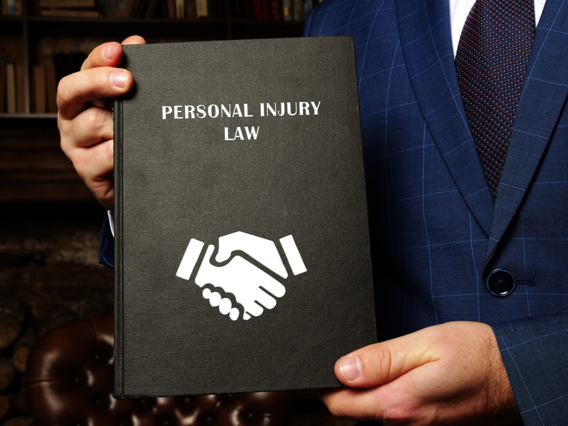 lawyer holding personal injury law book