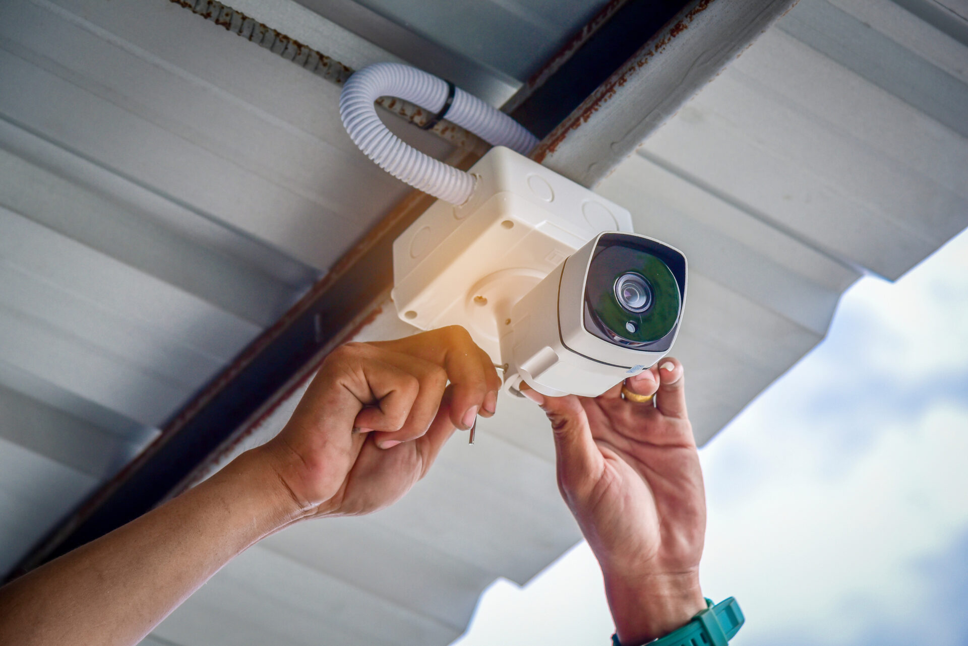 man installing a security surveillance camera