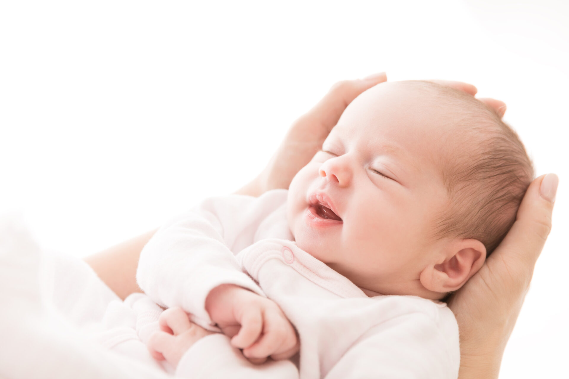 Woman embracing the pure joy of motherhood, tenderly holding her precious newborn baby