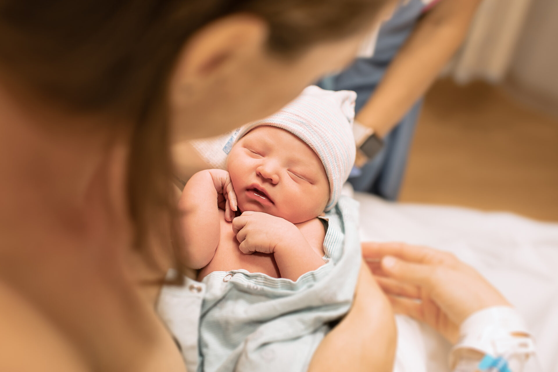 Tenderly cradling her precious newborn: A loving mother cherishes her baby's arrival.