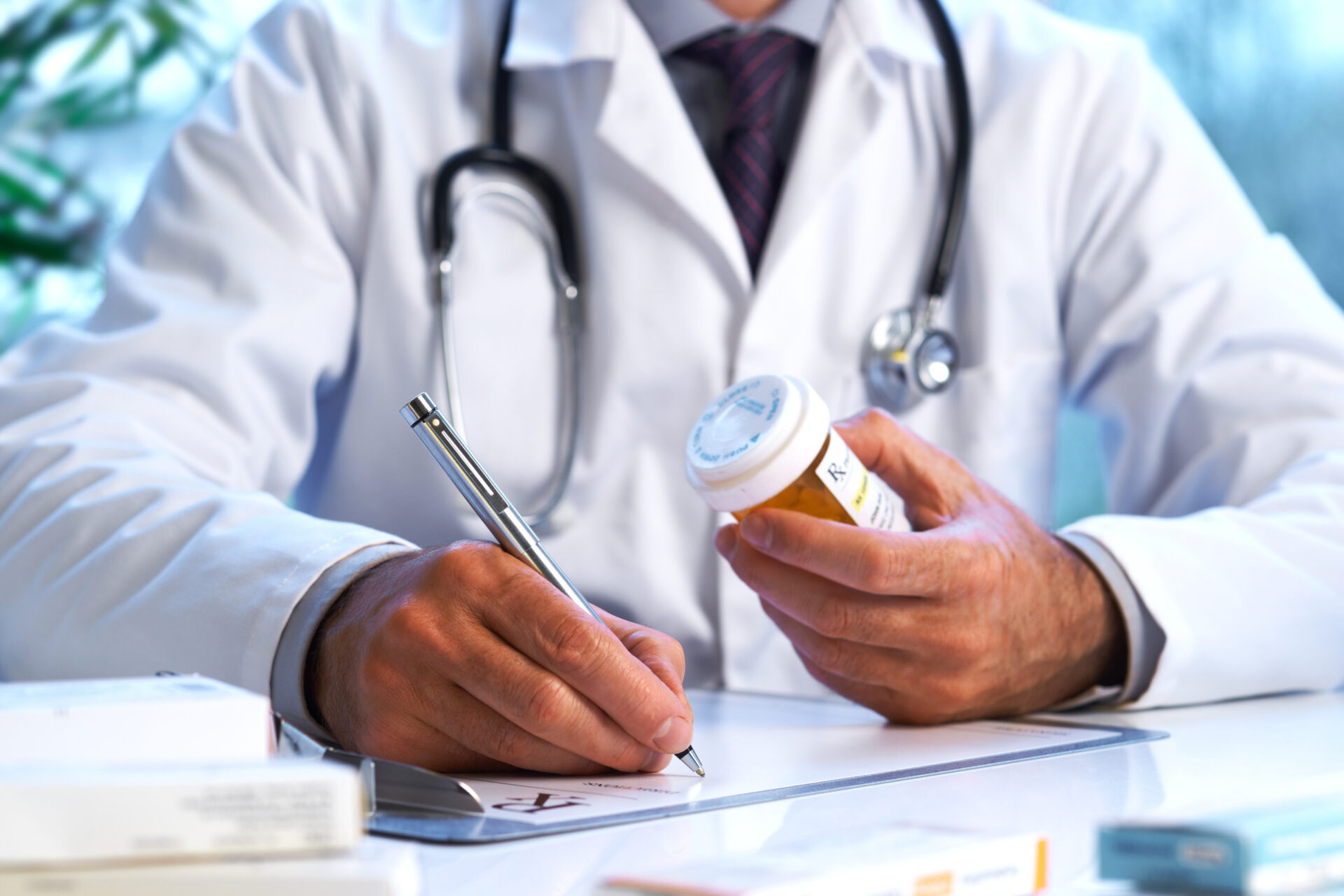 Diligent doctor holds pill bottle, ensuring accurate medication guidance composing a prescription