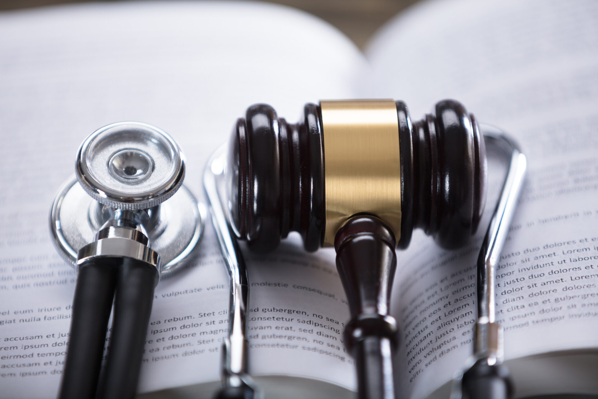 Medical and justice instruments together on top of a book