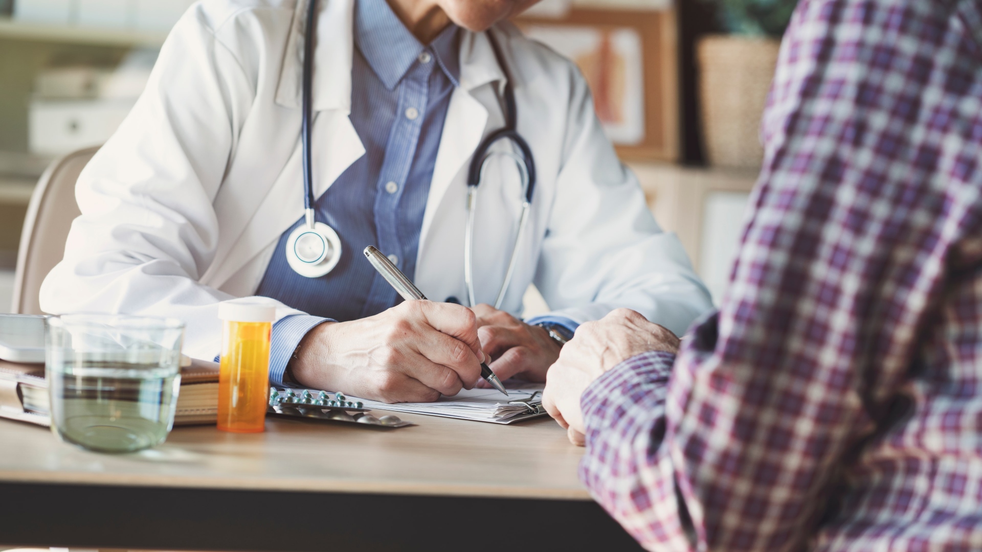 Legal Implications of Medication Errors - Doctor writing a prescription - The Pagan Law Firm
