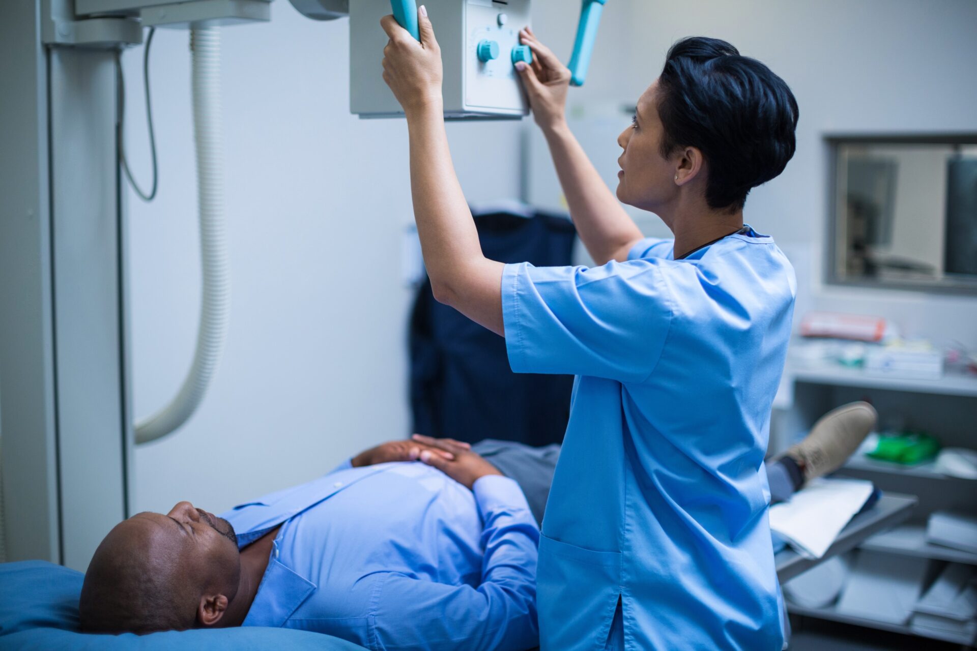 Doctor reviewing an X-ray with a patient in a clinical setting | X-ray overexposure when medical care leads to legal claims, medical malpractice lawsuits - The Pagan Law Firm